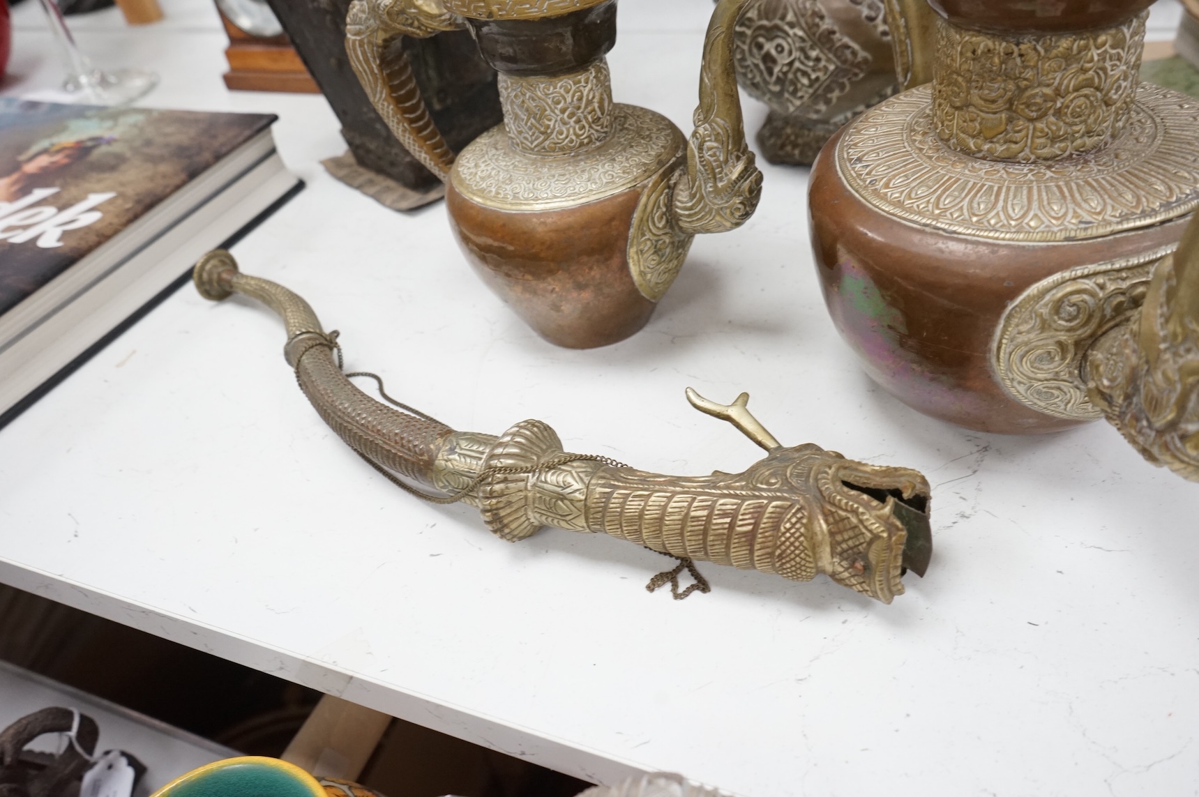 A collection of Asian embossed metalware, largest 41cm high